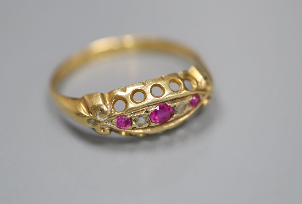 A George V 18ct gold, ruby and diamond chip set ring, size P, gross 2 grams.